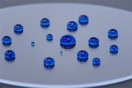 Water droplets beading on a substrate coated with the fluorine-free water repellent coating (developed product)